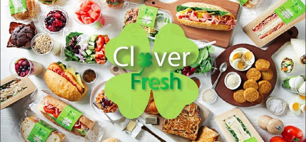 Clover Fresh logo with food items in the background