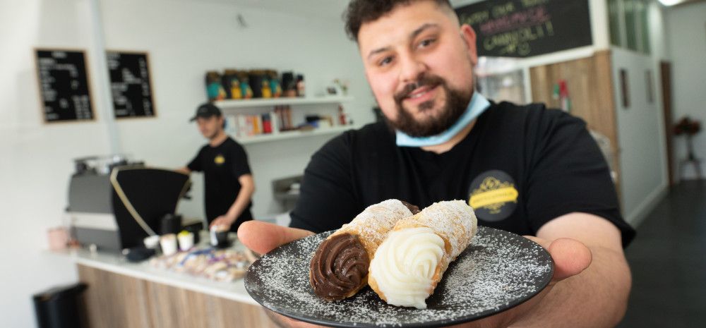 Joe holding a plate of cannoli