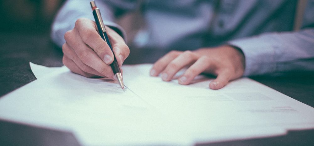 Man signing papers