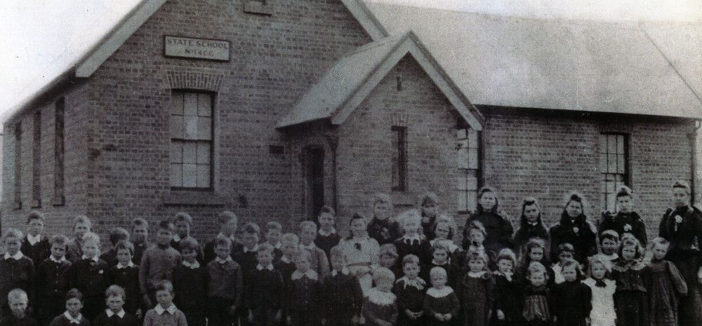Black and white image of students and teachers outside Keysborough State School