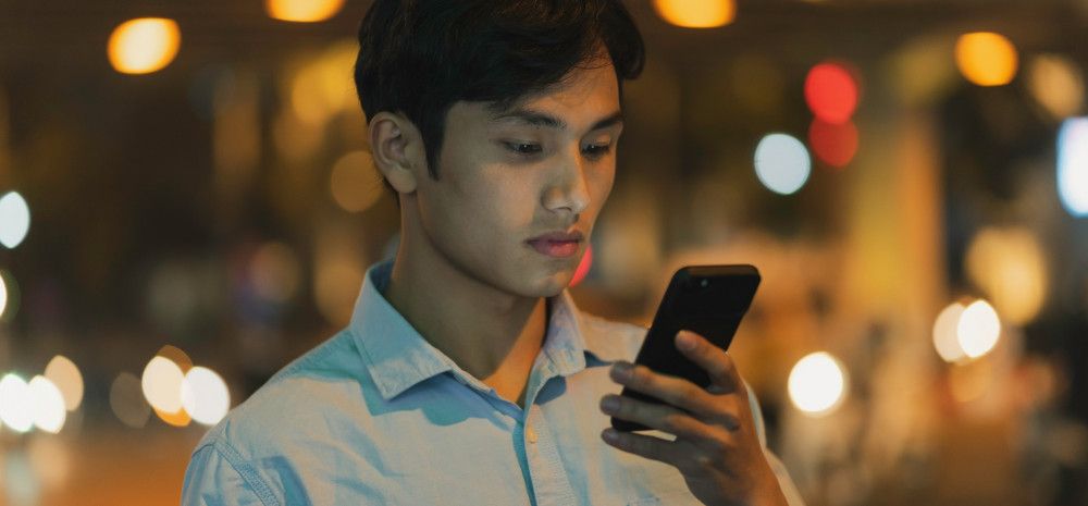 young man looking as his mobile phone