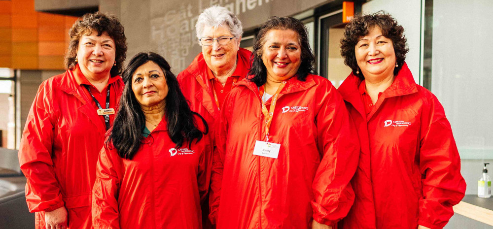 Greater Dandenong volunteers dressed in bright red jackets