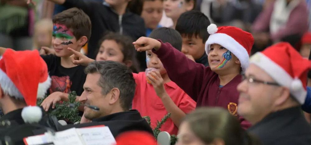 a group of people singing carols