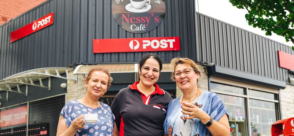 Three ladies standing in front of Nessys Cafe