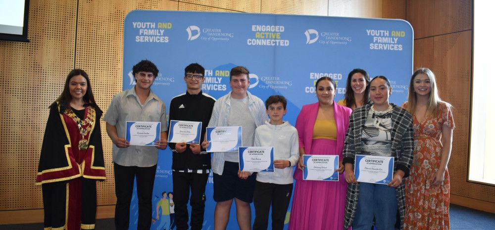 Mayor Eden Foster poses with a group of Young Leaders holding certificates