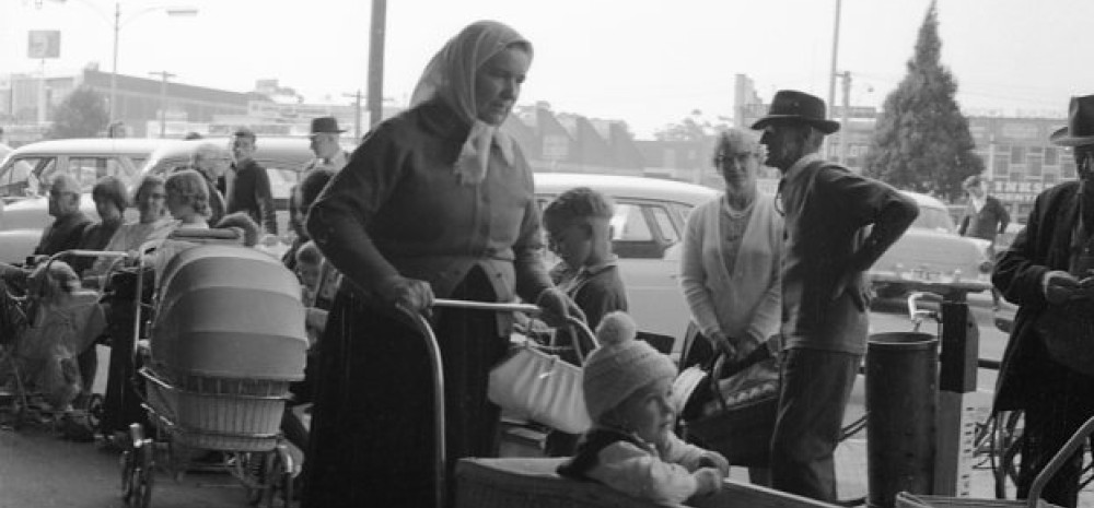 Black and white photo of Lonsdale Street circa 1970, with a woman and pram, with young child