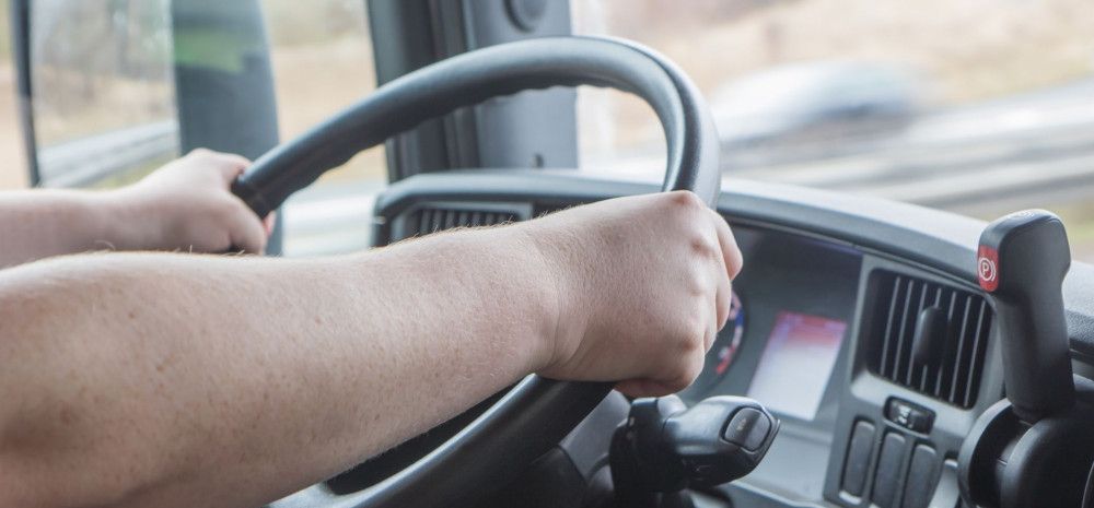 a person in the driver's seat of a truck