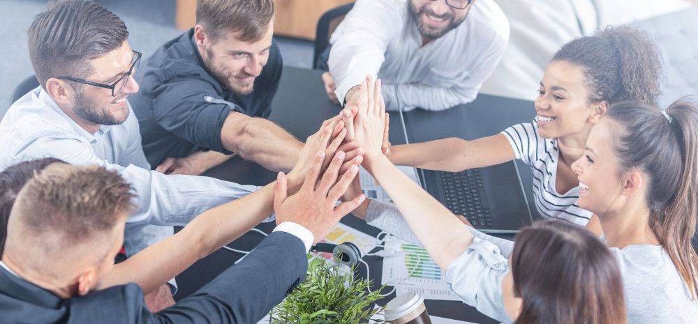 corporate staff having a high five