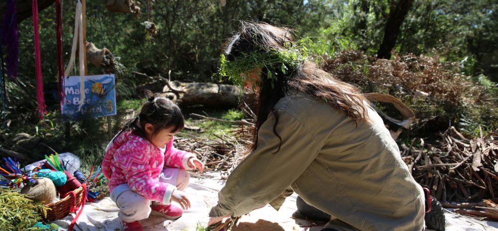 a ranger doing craft outside with a toddler