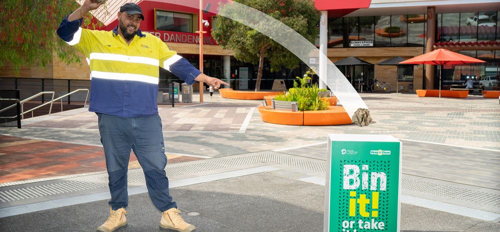 Man throwing rubbish in a bin