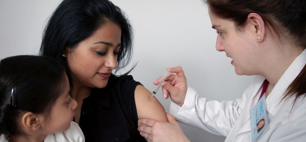 Lady receiving an immunisation injection