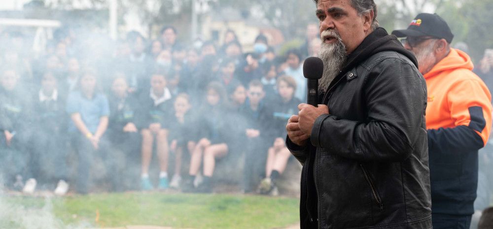 an Aboriginal man speaking at a smoking ceremony