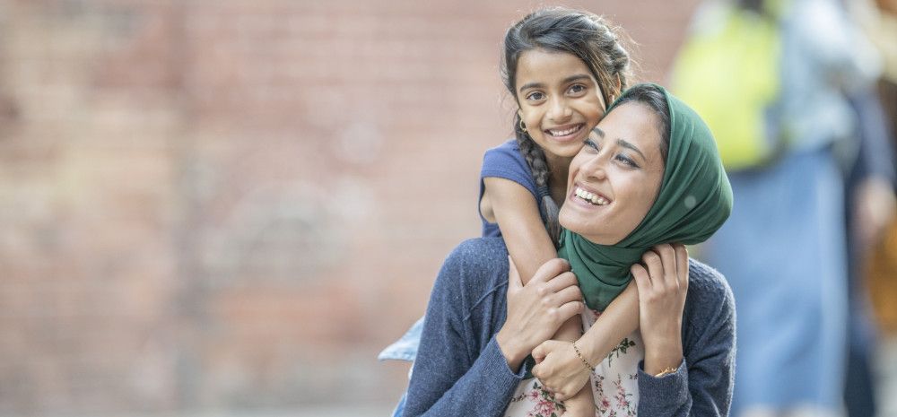 a mother and child smiling at the camera