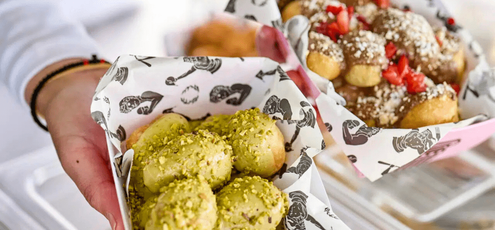 A baker presenting desserts.