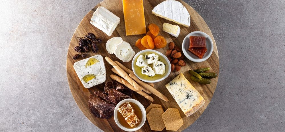 different cheeses and biscuits on a board