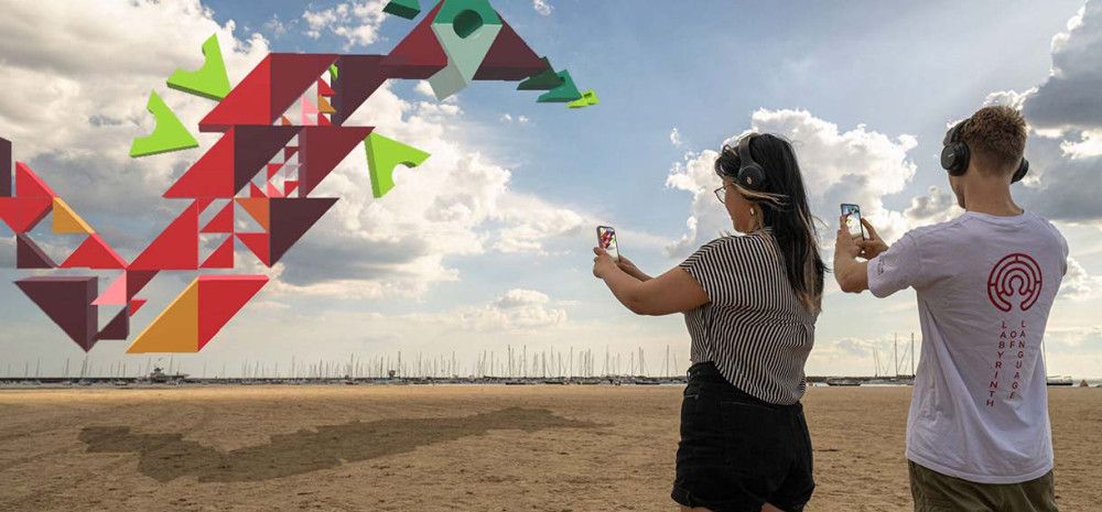 Two people looking at an abstract image through their phones