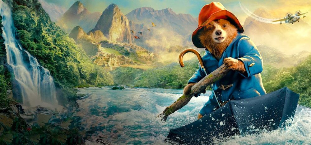 Paddington Bear white water rafting down a river in his umbrella