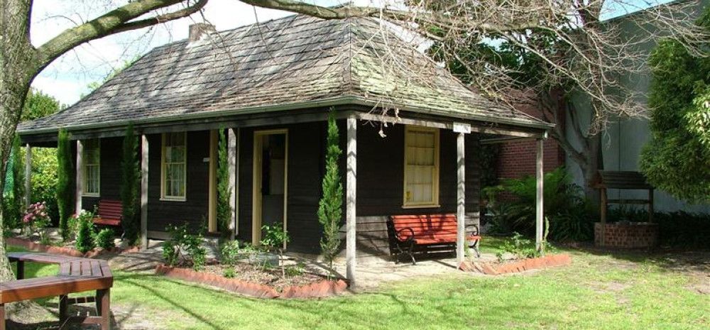 outside of the house with grass and trees