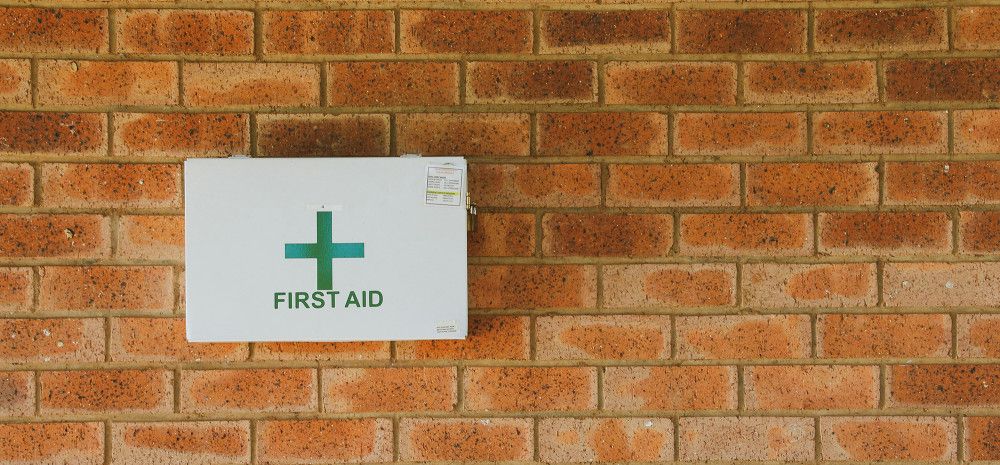 First Aid box mounted on a brick wall