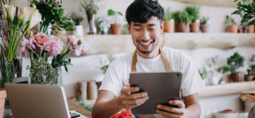 business owner in shop looking at ipad
