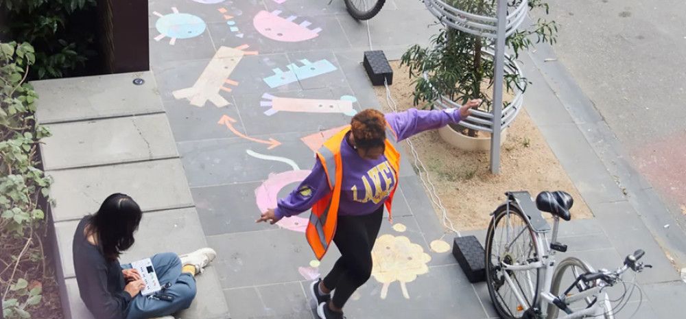 People playing on the footpath
