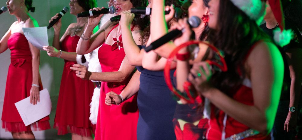Performers on stage singing carols