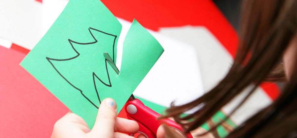 Someone cutting out a Christmas tree