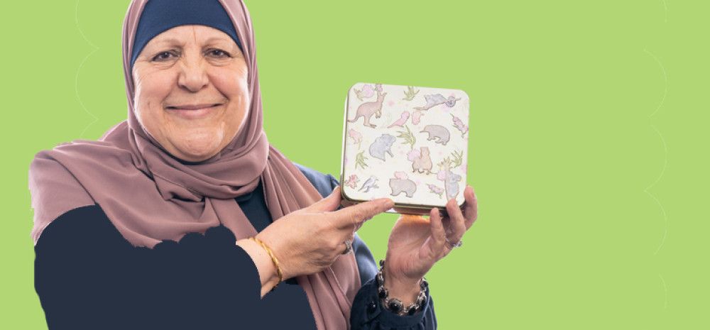 Woman holding a biscuit tin