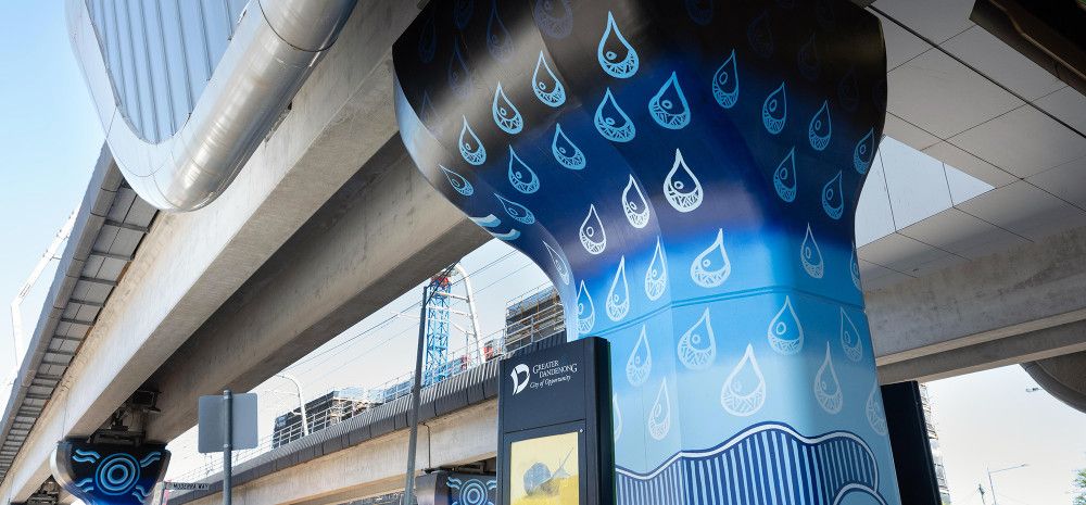 Muderra artwork on a concrete pole