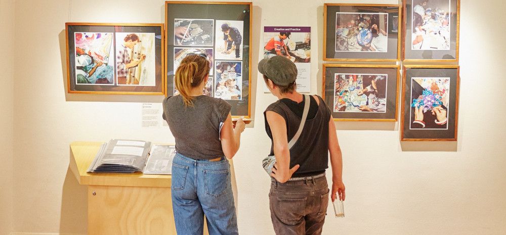 People looking at exhibition display.