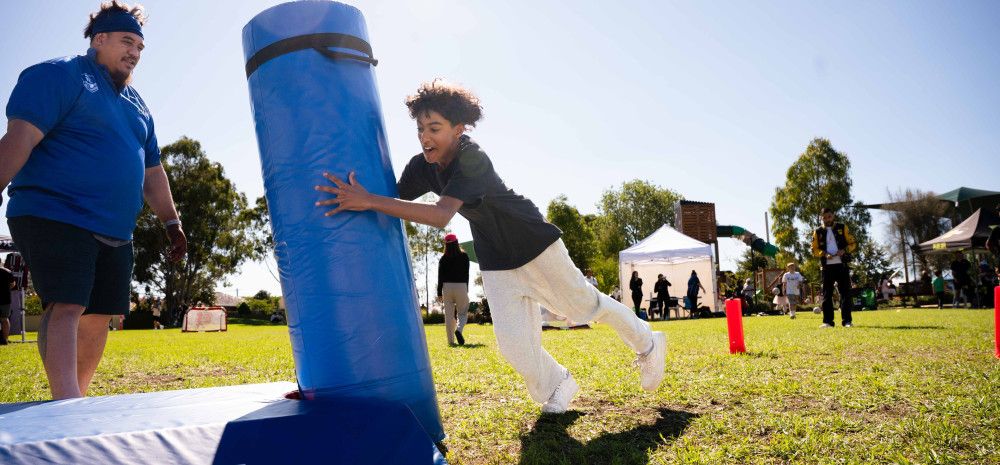 Child running up to tackling pad