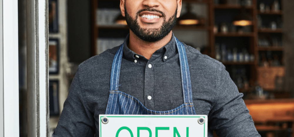 business owner holding sign