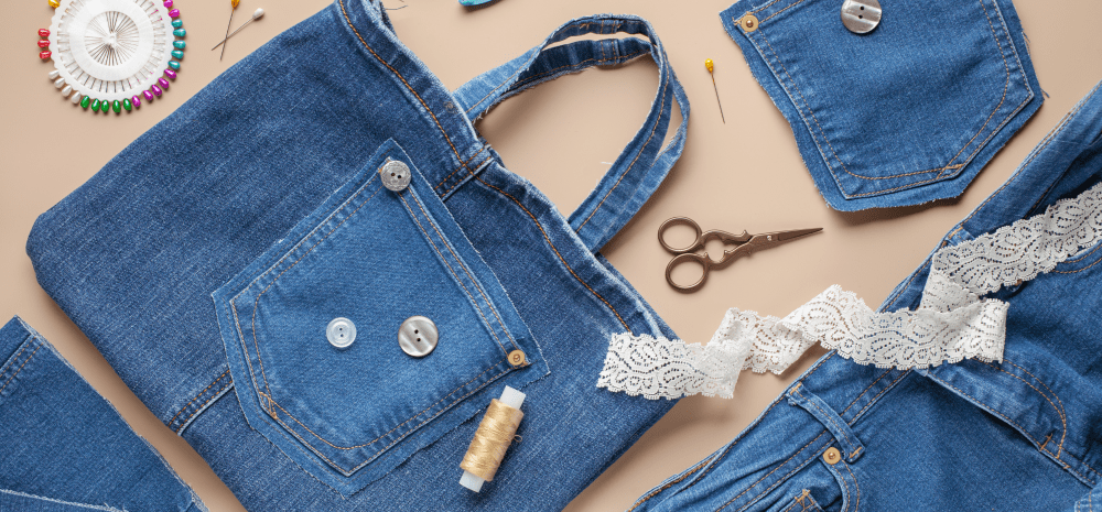 A denim tote displayed on the table with sewing paraphernalia.