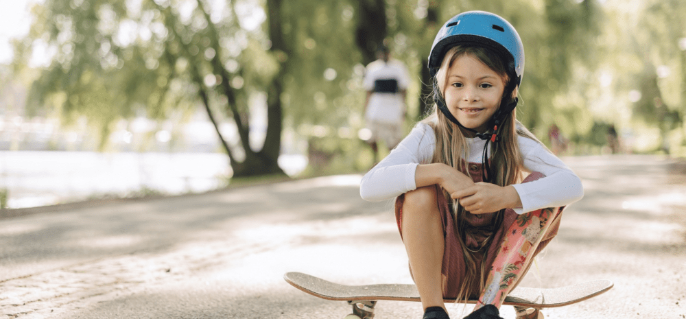 Child sitting on a skateboard