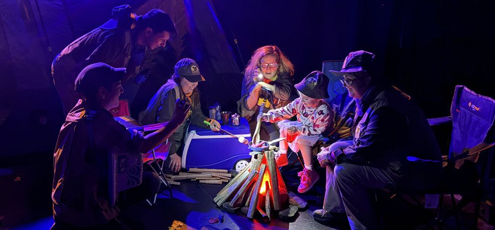 Camping tent and mock fire in a theatre