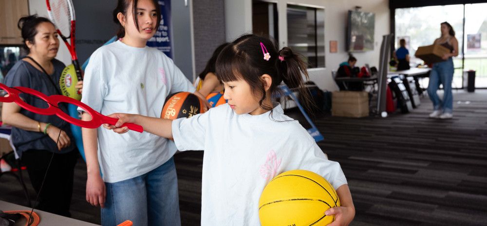 Child sifting through sports equipment