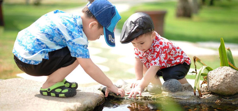 Two children looking through the water