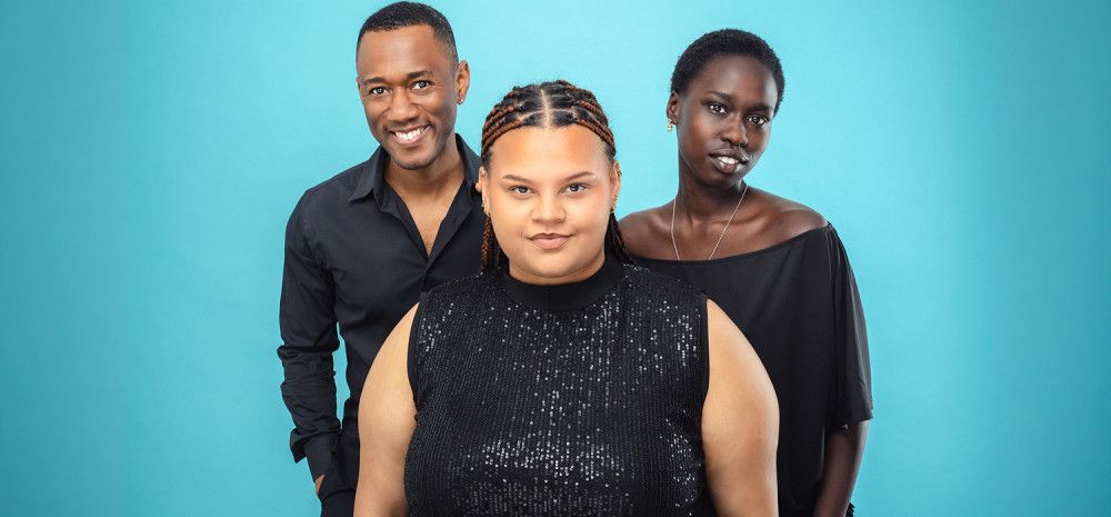 Three people smiling