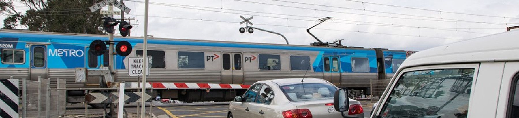 a level crossing with a train going past