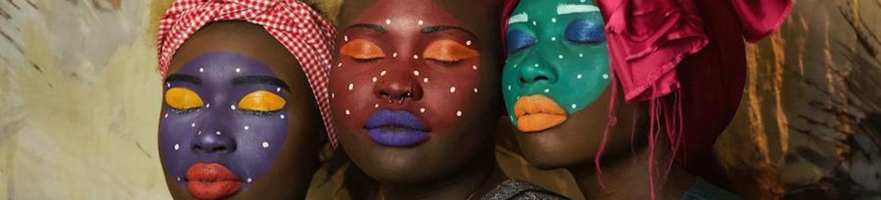 Three women with painted faces