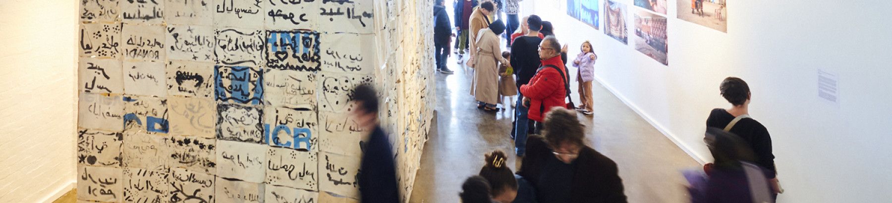 People looking at the HOME 25 exhibition
