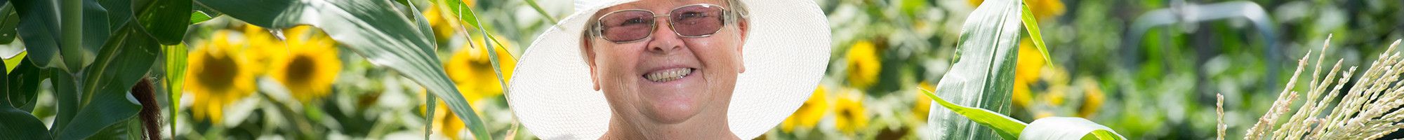 Smiling lady amongst community garden