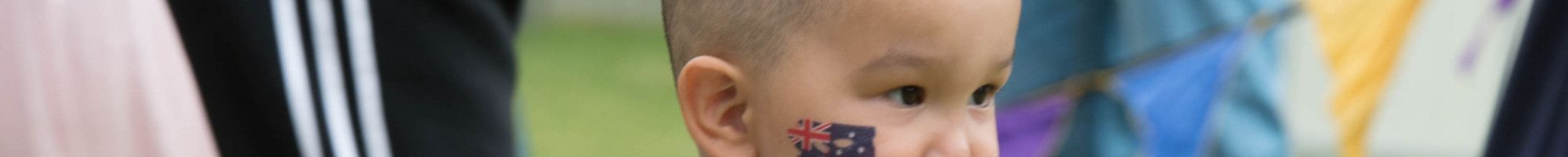 toddler with Australian flag tattoo on his cheek