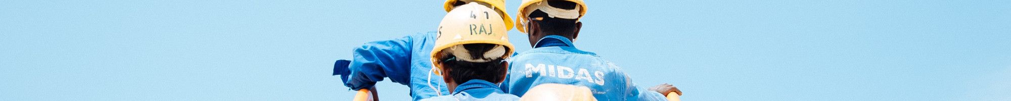 workers in hard hats climbing a ladder