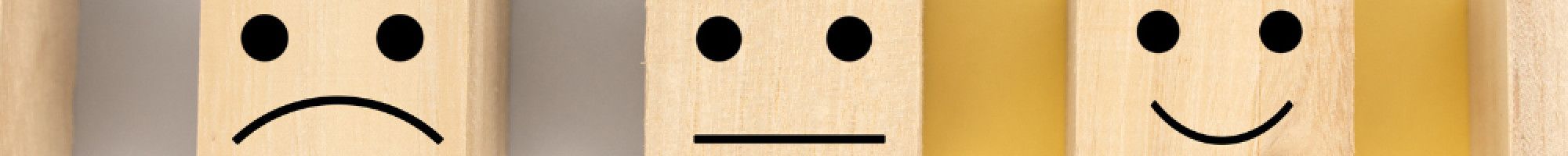 Wooden boxes with smiley and sad faces