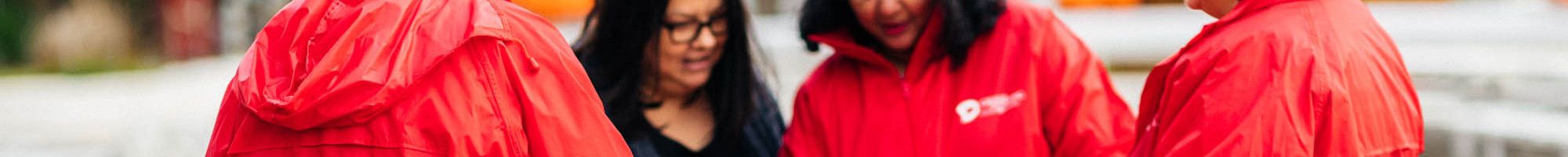 people in red jackets standing in a circle