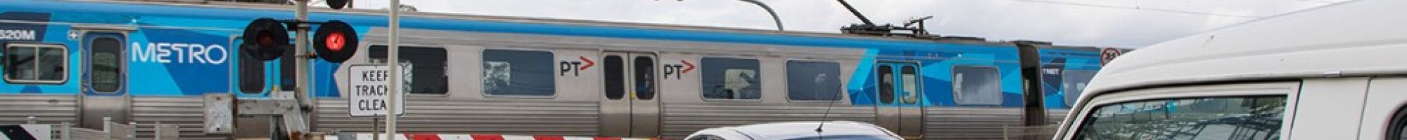 a level crossing with a train going past