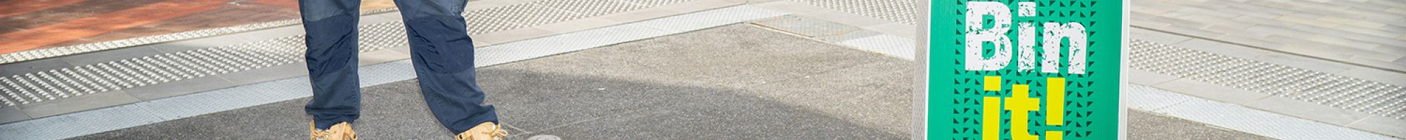 Man throwing rubbish in a bin