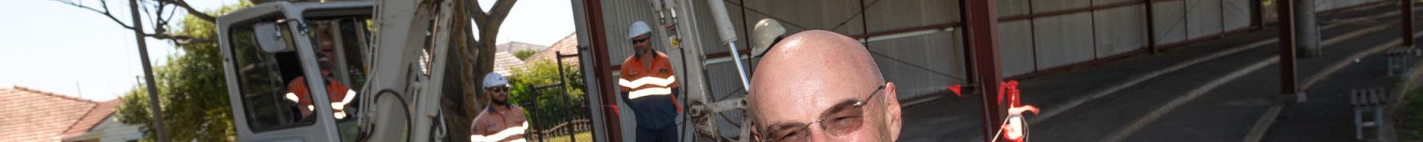 Councillor Sean O'Reilly standing in front of a work site.