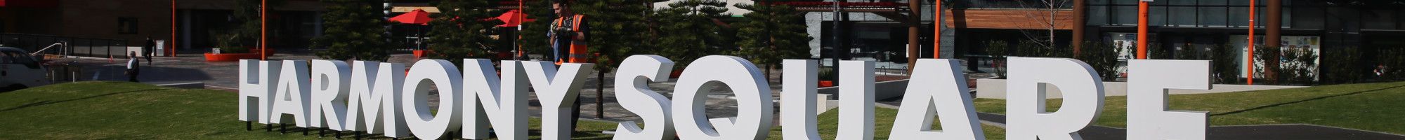 Dandenong Civic Centre with the white letters Harmony Square on the grass.
